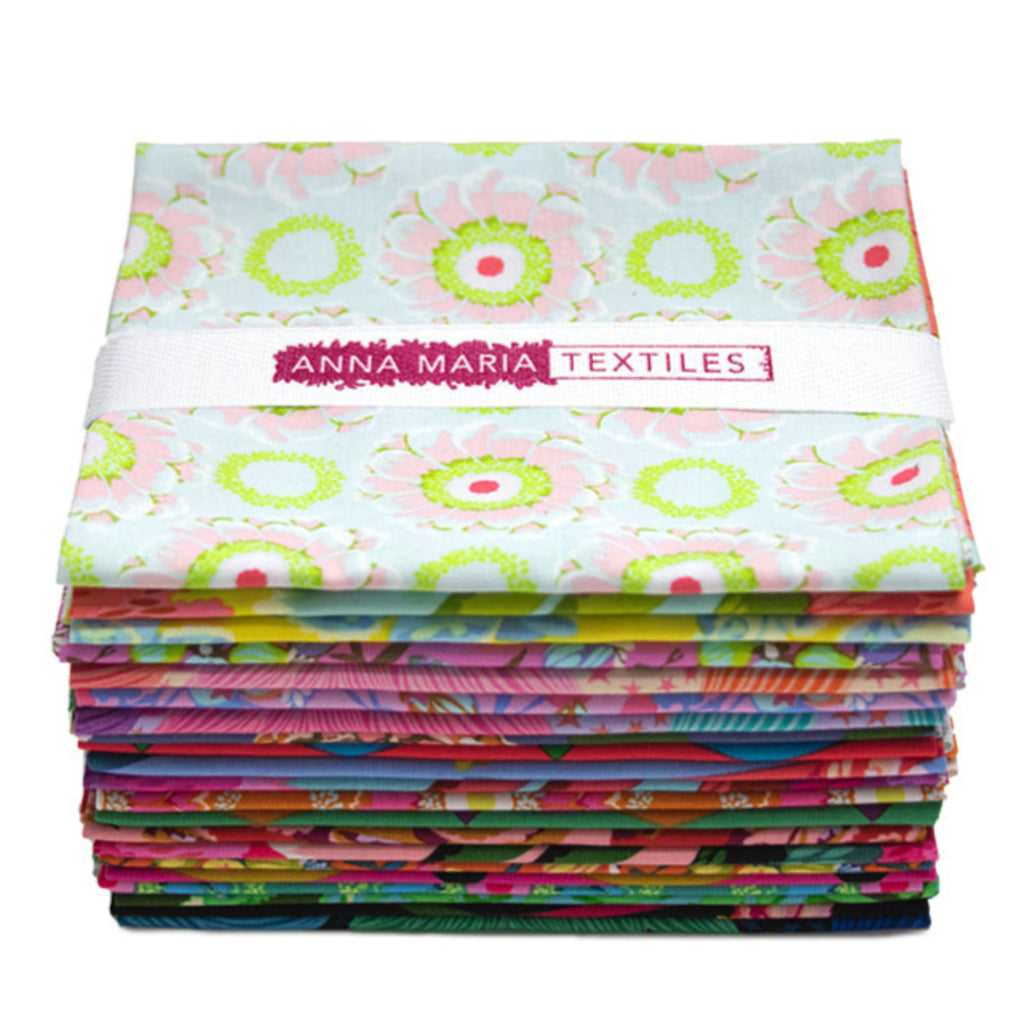Stack of colorful fabric packets with 'Anna Maria Textiles' branding on a white background