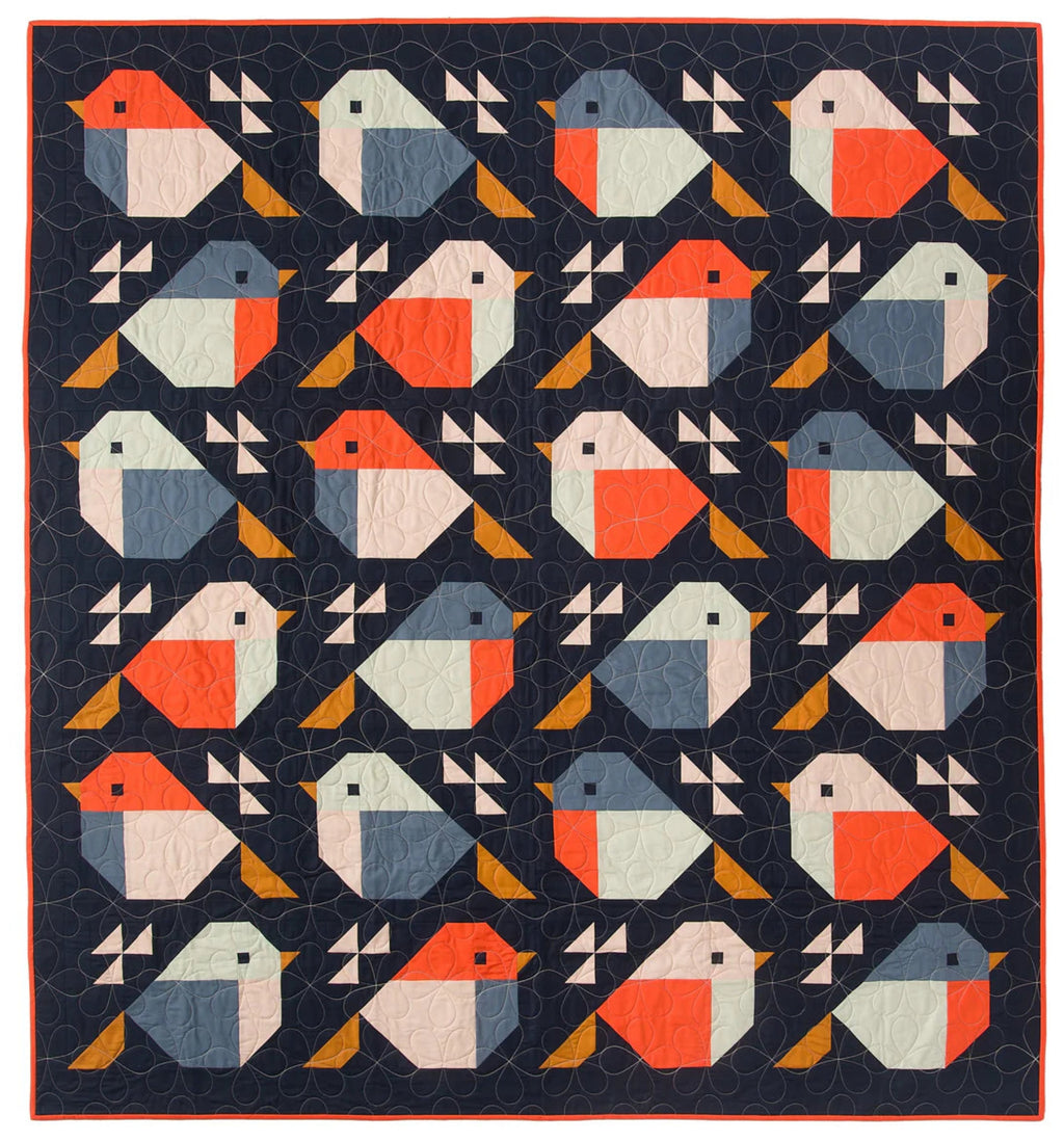 Quilt with geometric bird pattern on a dark blue background