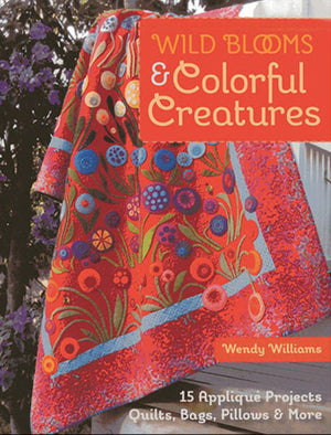 Book cover of 'Wild Blooms & Colorful Creatures' by Wendy Williams featuring a colorful quilt.