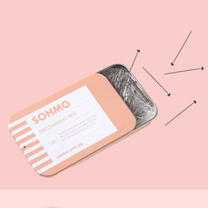 SOHMO hairpin tin with hairpins on a pink background