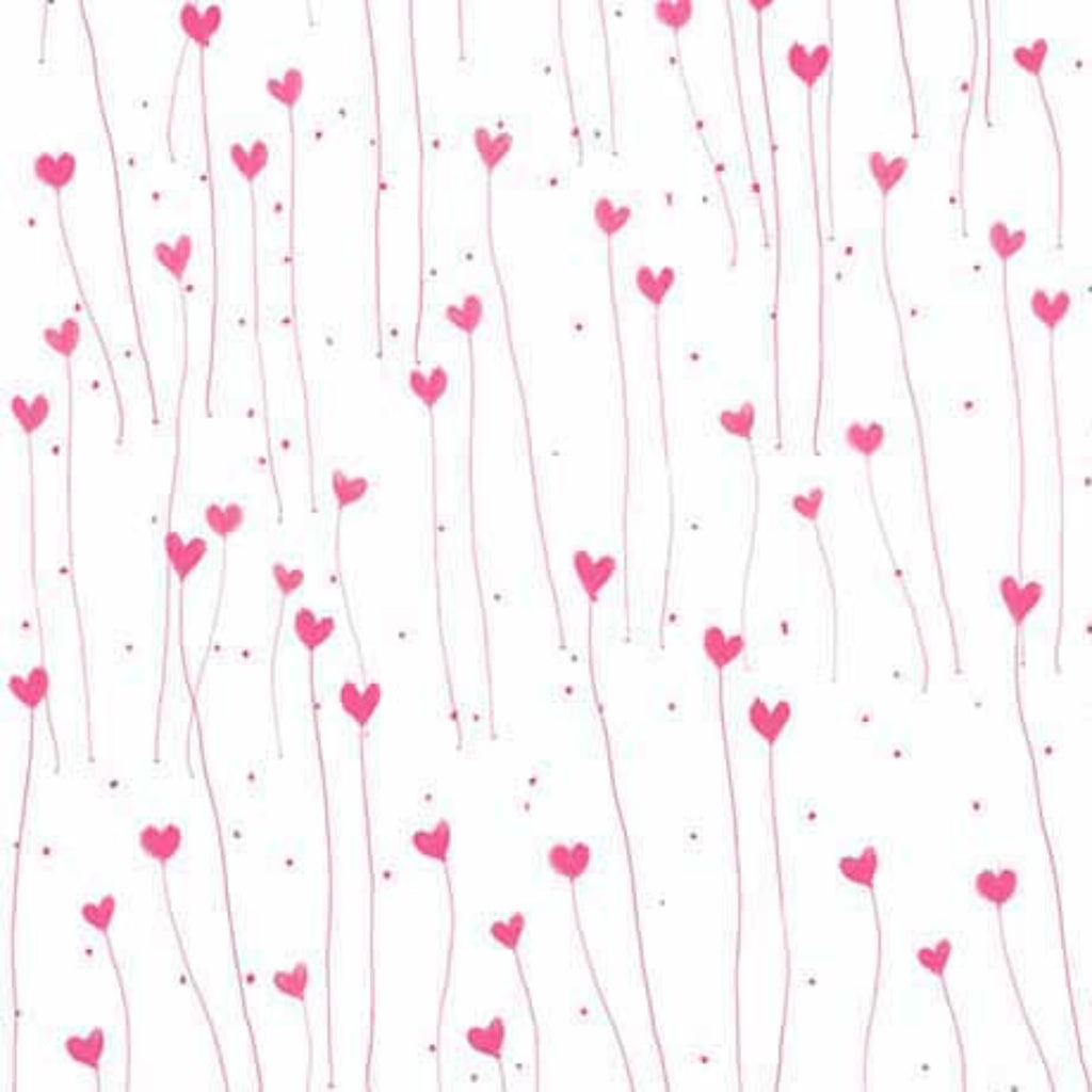 A fabric with a pattern of white and pink hearts and hearts-shaped seashells.