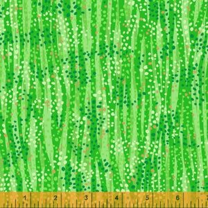 A green fabric with metallic embellishments, displaying a pattern of grass-like strands with sparkling dots.