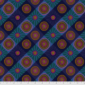 A fabric with a repeating geometric pattern featuring circles and spirals in shades of blue and purple.