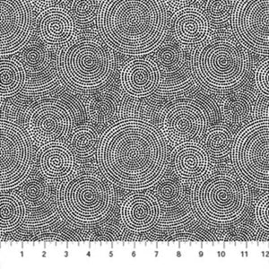 A fabric with a geometric circular mosaic dot pattern in white and black.