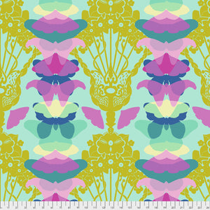 A fabric featuring a repeated pattern with floral and abstract designs in a vibrant mix of purple, pink, blue, green, and yellow colors.