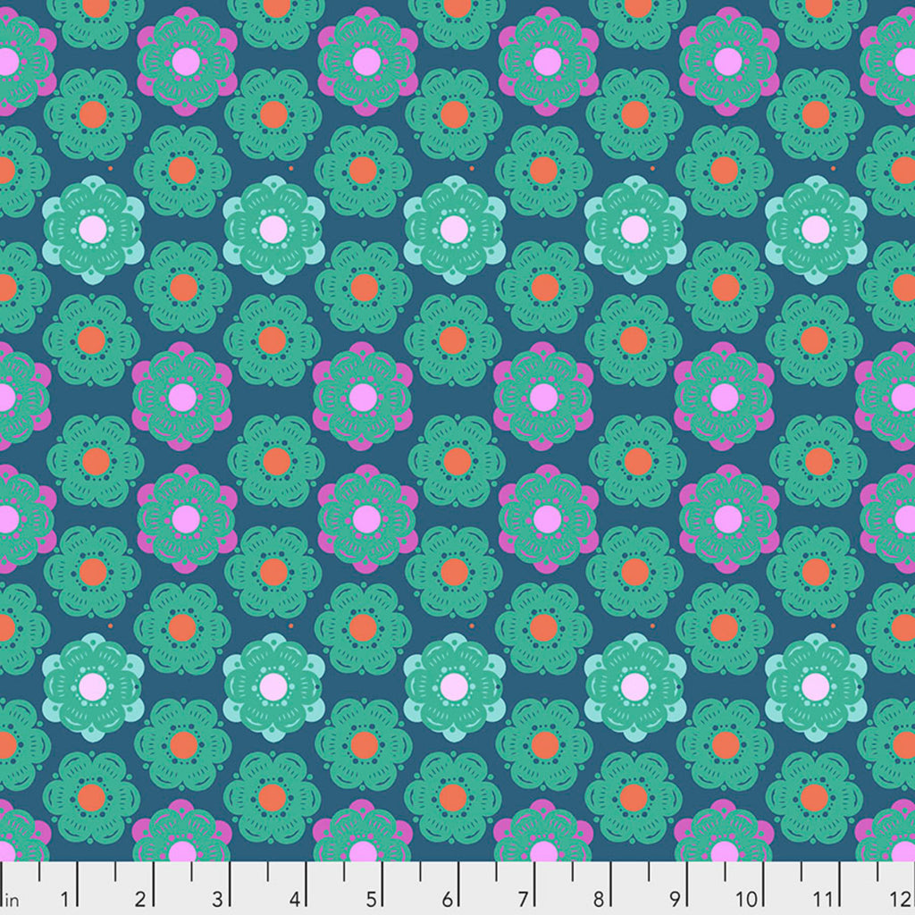 A fabric featuring a geometric honeycomb pattern with denim blue background and multicolor flowers.