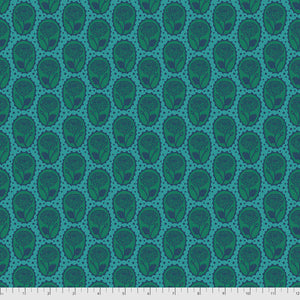A fabric with a geometric pattern featuring a repeating design of interconnected circles in shades of blue and green.