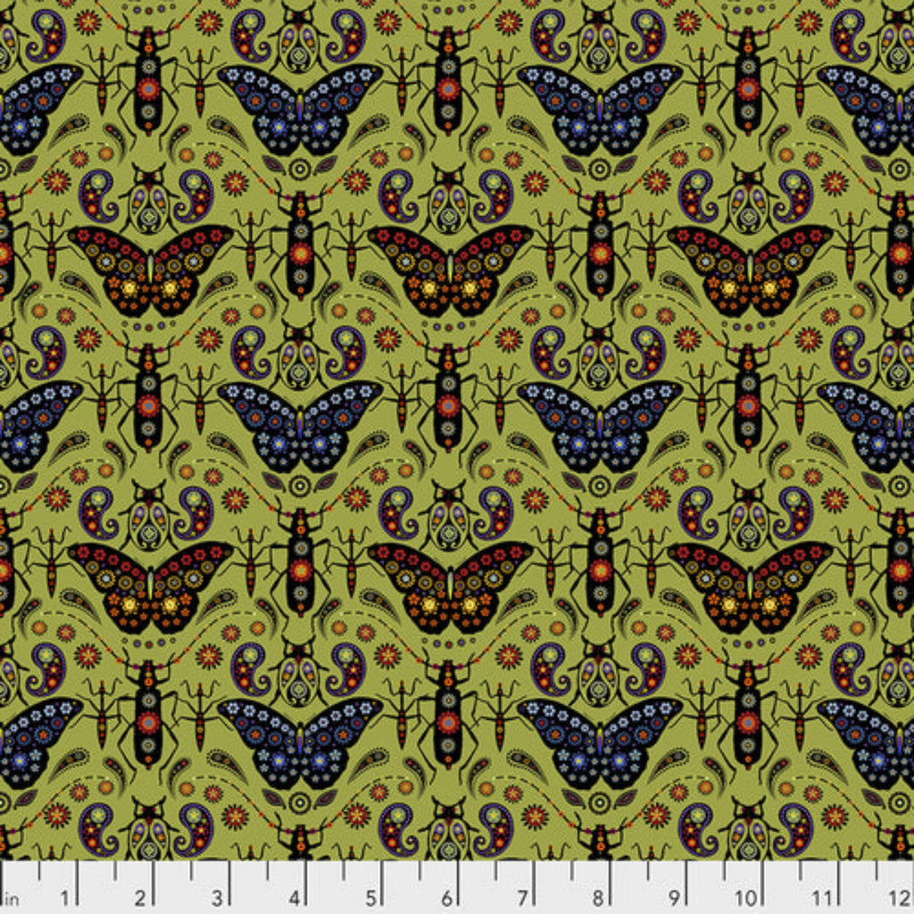A printed fabric featuring a repeating pattern of colorful butterflies on a green background, with a ruler at the bottom for scale.