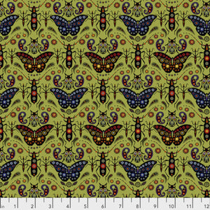 A printed fabric featuring a repeating pattern of colorful butterflies on a green background, with a ruler at the bottom for scale.
