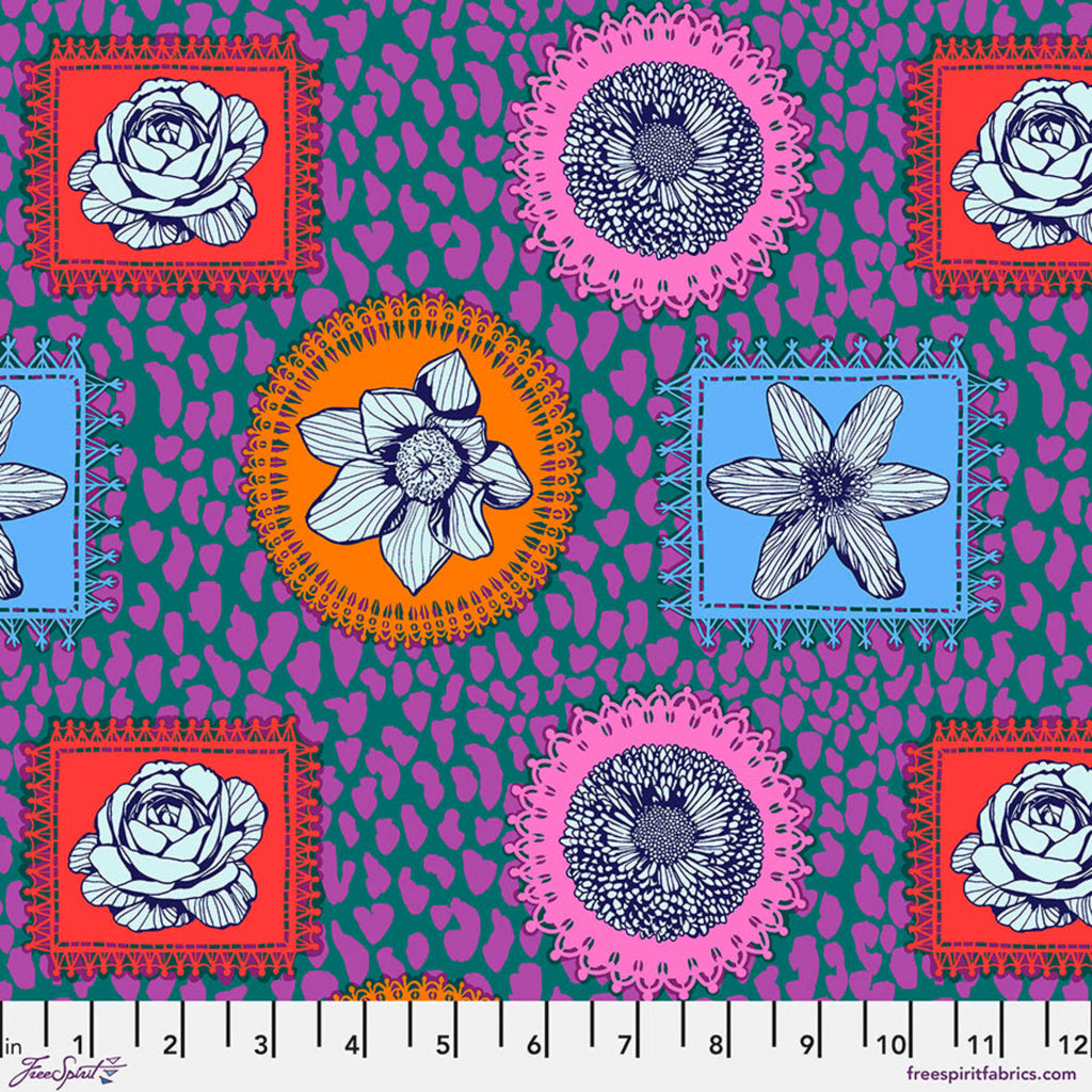 A piece of fabric featuring a geometric and floral pattern with prominent colors such as pink, blue, and orange.