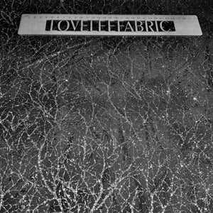 Black fabric with a textured silver metallic thread.