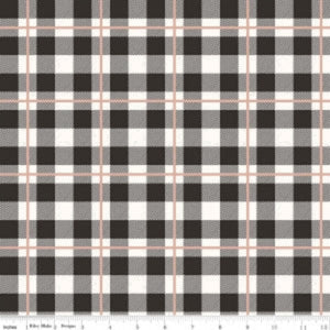 A piece of fabric with a checkered pattern in black, cream, and rose gold colors, indicating a metallic finish.