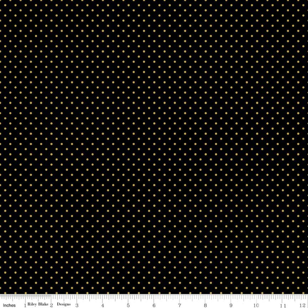 A piece of black fabric with gold metallic dots, indicating a patterned texture.