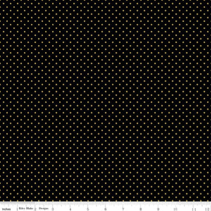 A piece of black fabric with gold metallic dots, indicating a patterned texture.